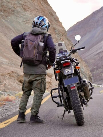 Driving through the Himalayas on a motorcycle (photo by Anand Yadav, Unsplash).