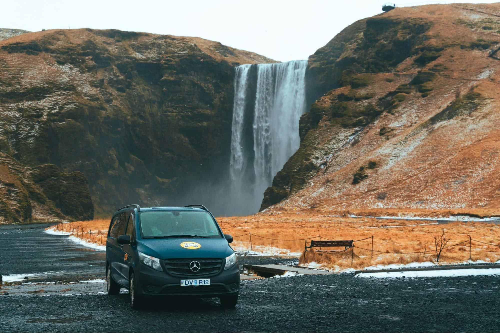 Mercedes campervan in front of a waterfall in Iceland.
