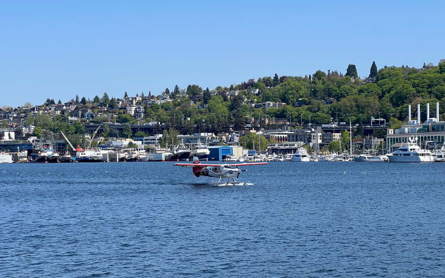 A Kenmore Air seaplane taxis after landing on Lake Union.