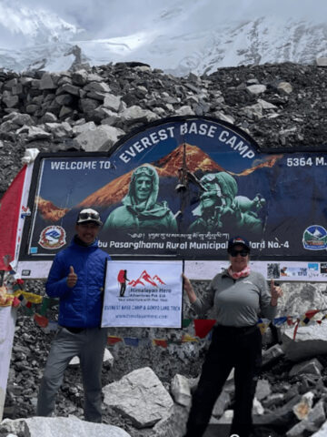 A trekker with the Everest Base Camp sign.