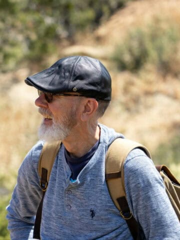 An older adult backpacking (photo: David Brown, Pexels).