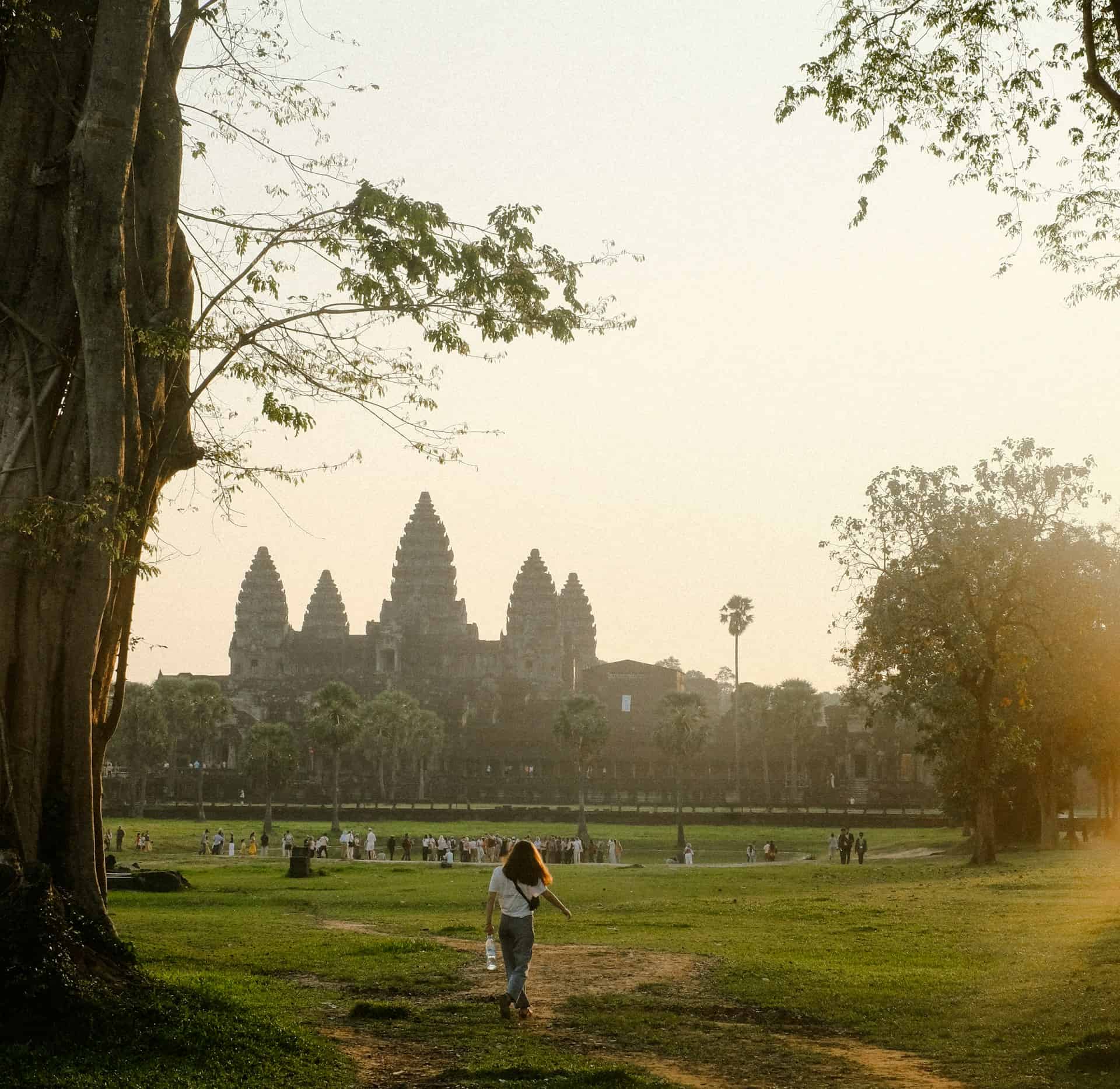 A woman visits Angkor Wat at sunrise in Cambodia (photo: alicharmant).