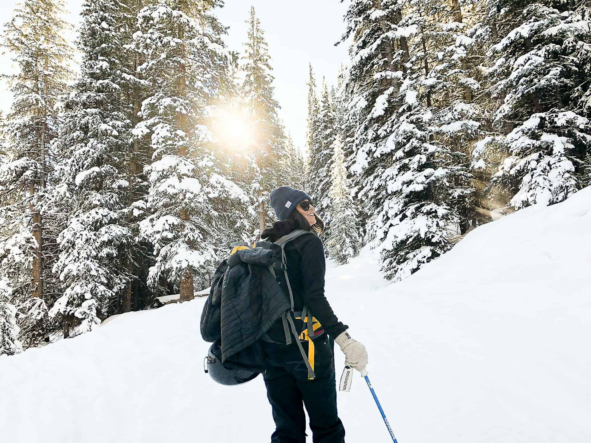 Whether you go off-piste or stay on groomed trails, pack a helmet for your ski trip. Pictured: a backcountry skier in Mayflower Gulch Trail - Frisco, Colorado (photo: Holly Mandarich).