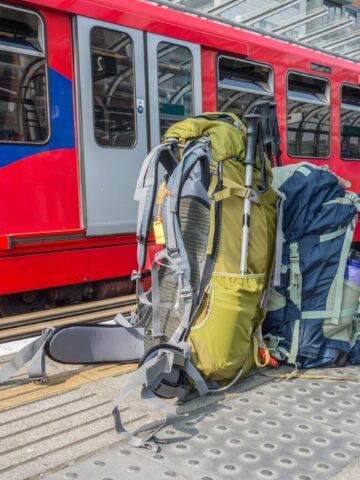 A pair of backpacks rest on a train platform (photo: Ian Taylor).