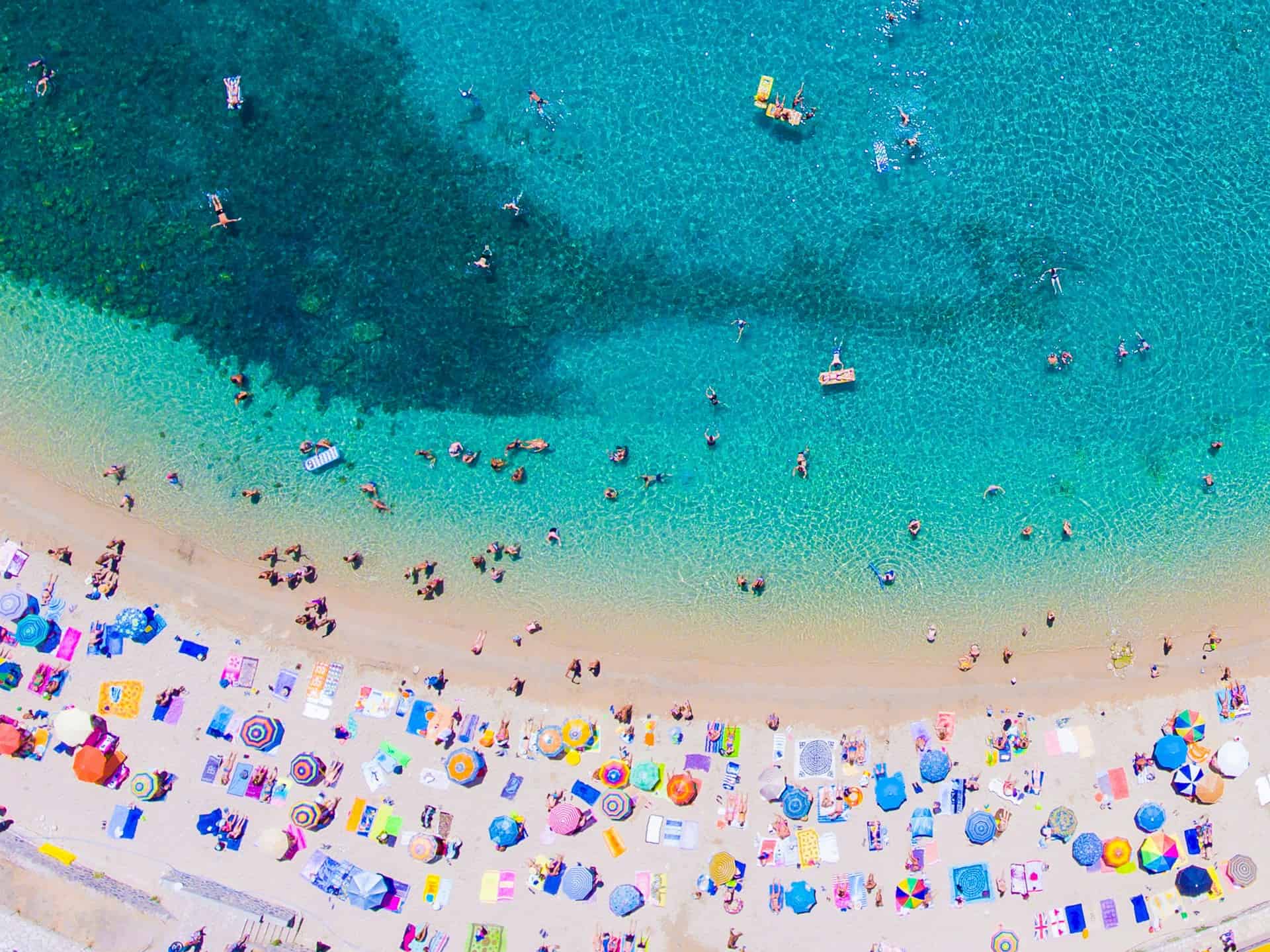 Aerial view of a beach and turquoise waters on Corfu (photo: Calin Stan, Unsplash). Aerial view of a beach and turquoise waters on Corfu (photo: Calin Stan, Unsplash).
