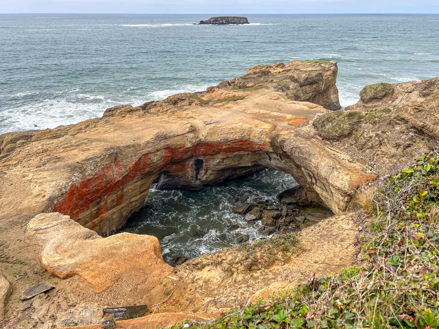 The Devils Punchbowl Arch at high tide. The Devils Punchbowl Arch at high tide.