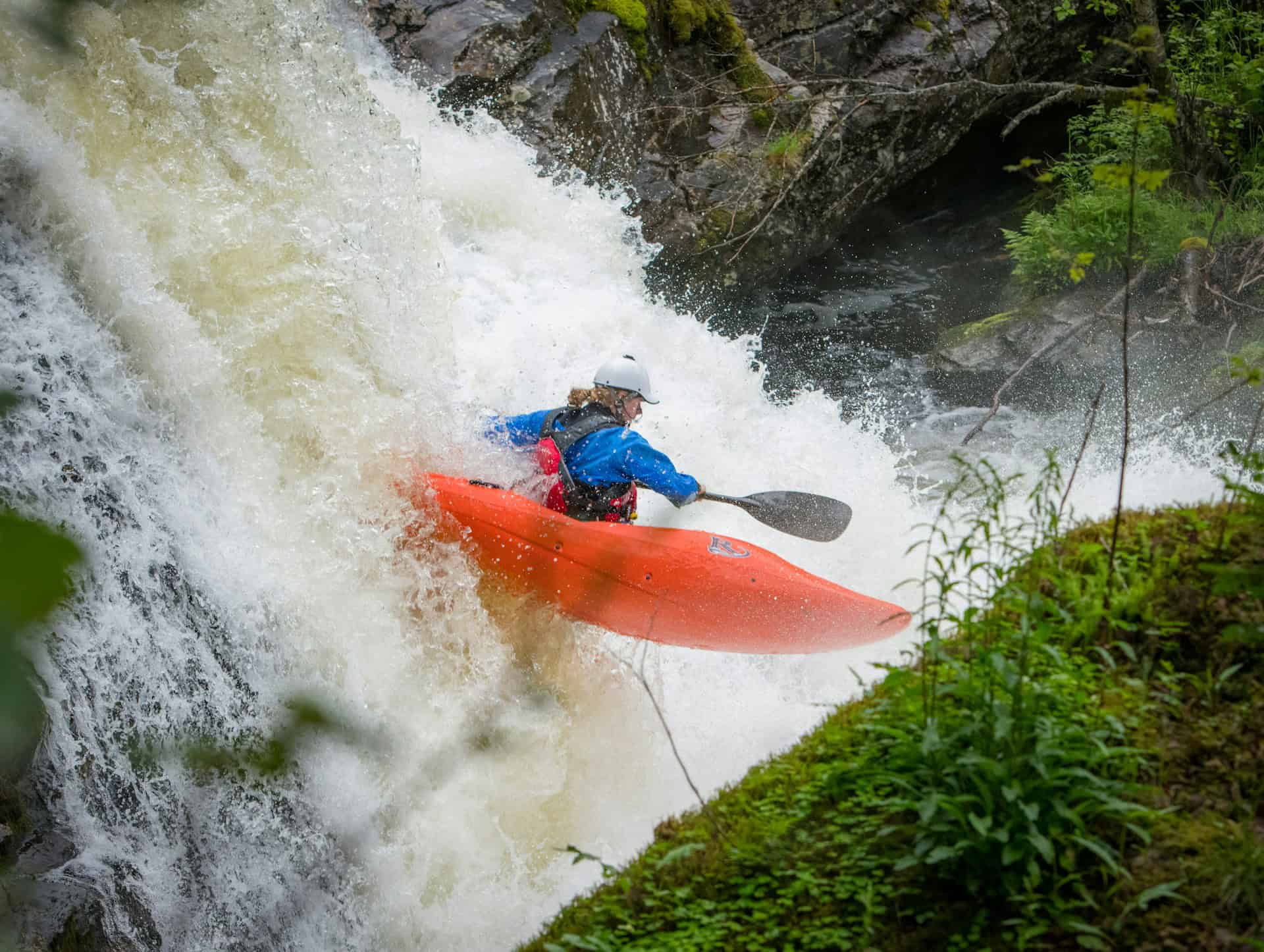 A kayaker navigates a waterfall near Voss, Norway (photo: Rune Haugseng, Unsplash).