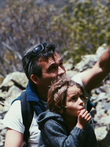 A father and child hiking in Champoléon, France (photo: Mael Balland, Unsplash).