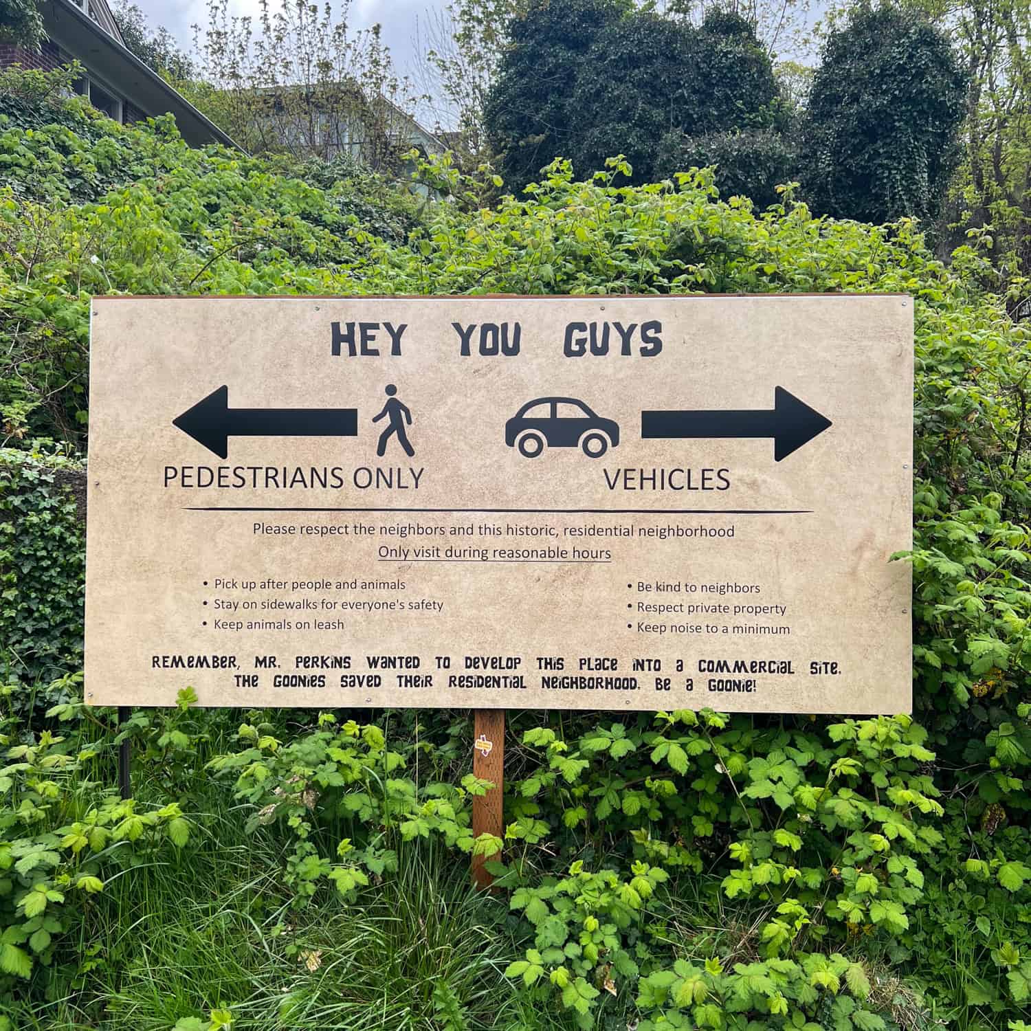 A sign instructs visitors on how to respectfully visit Mikey's house, which is a private residence.