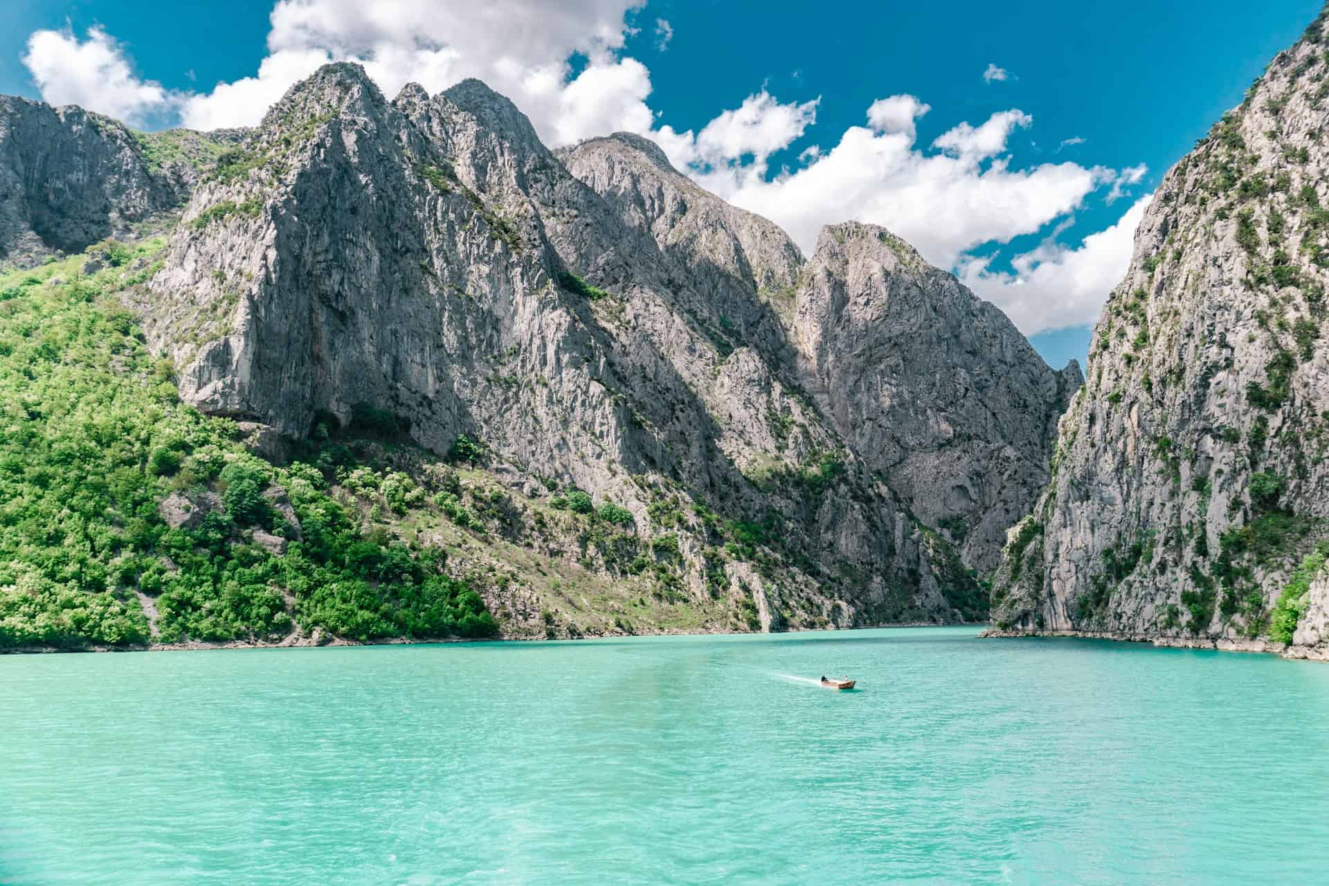 Komani Lake in Albania, one of the cheapest places to visit in Europe (photo: Johnny Africa, Unsplash).