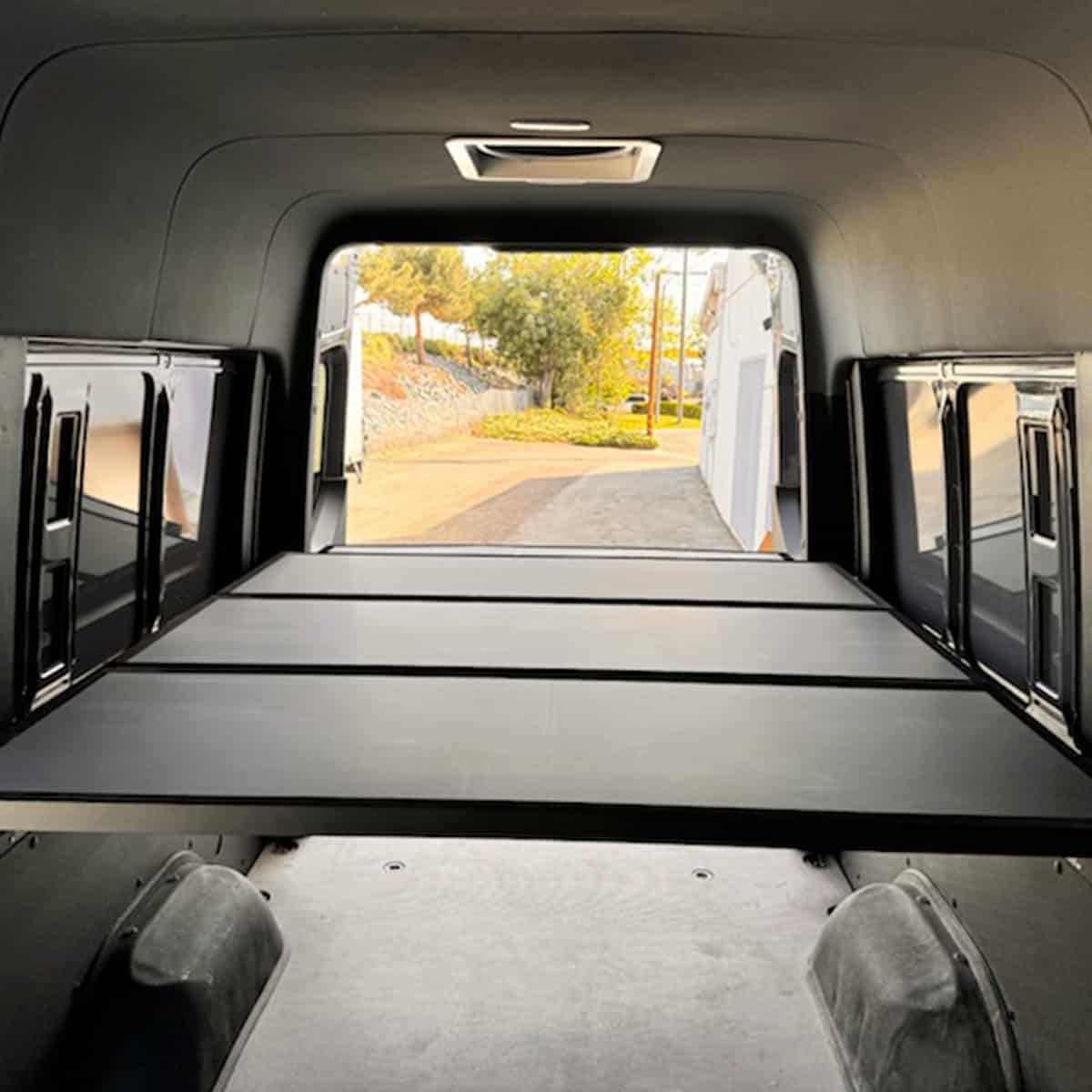 Adjustable bed system installed in a van.