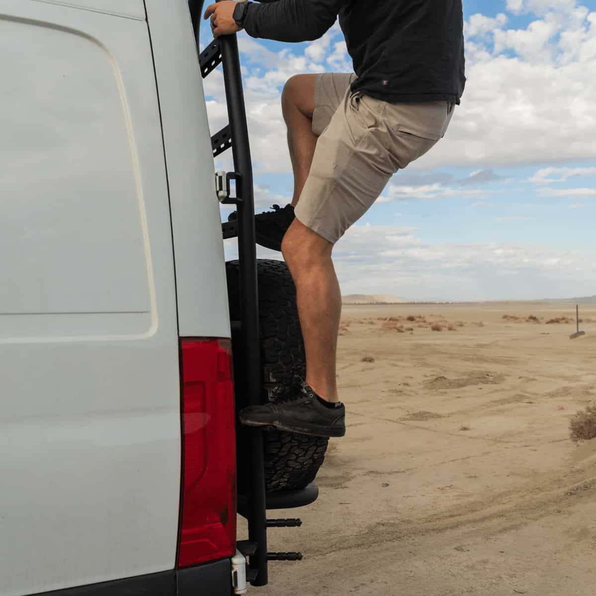 A man climbing up the White Top Adventures Rear Tire Carrier Ladder.