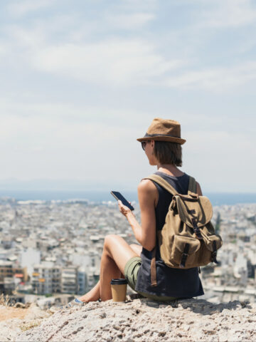 A traveler using her phone with an eSIM service in Italy (photo: Poike, iStock license).