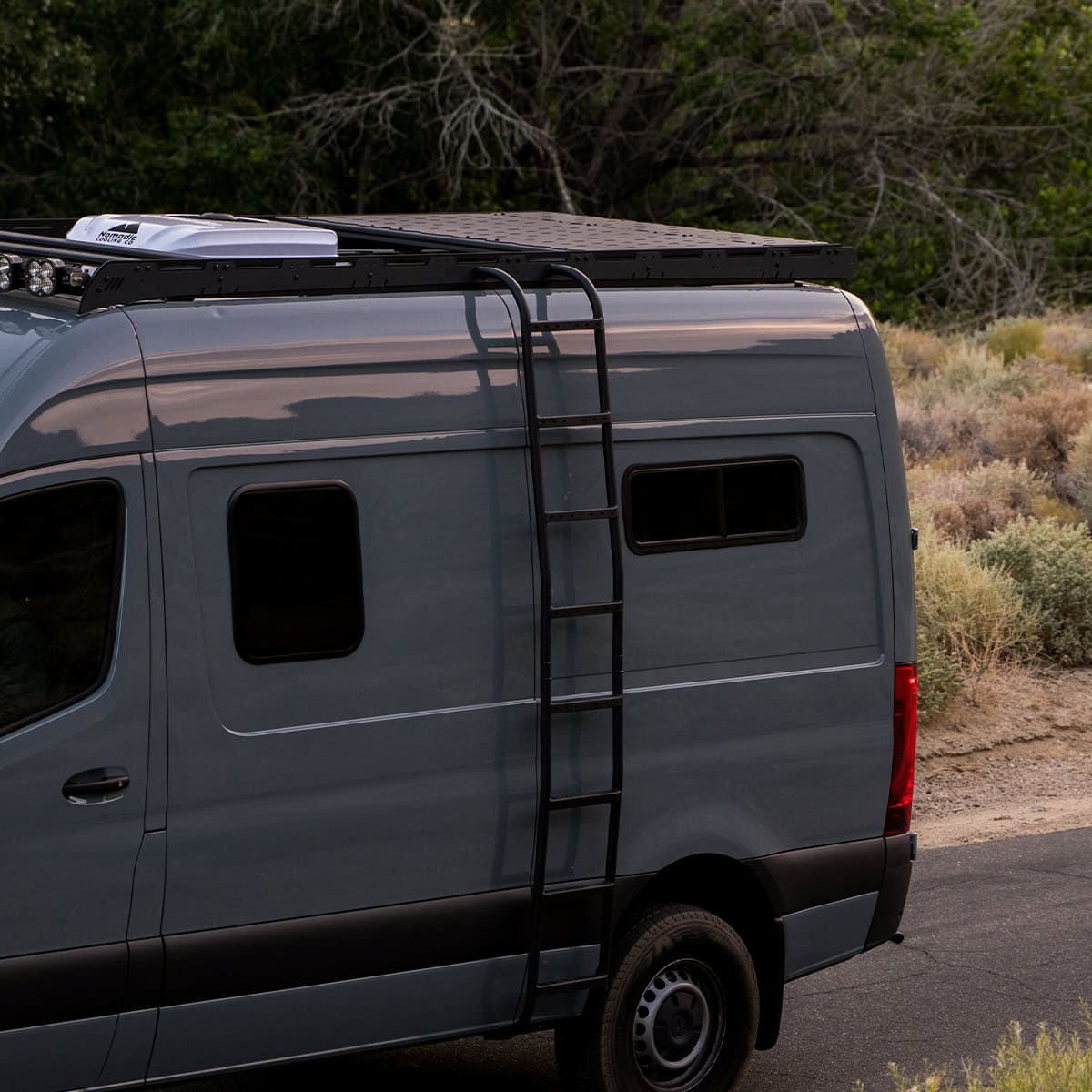 White Top Adventures roof rack on a grey Sprinter van.