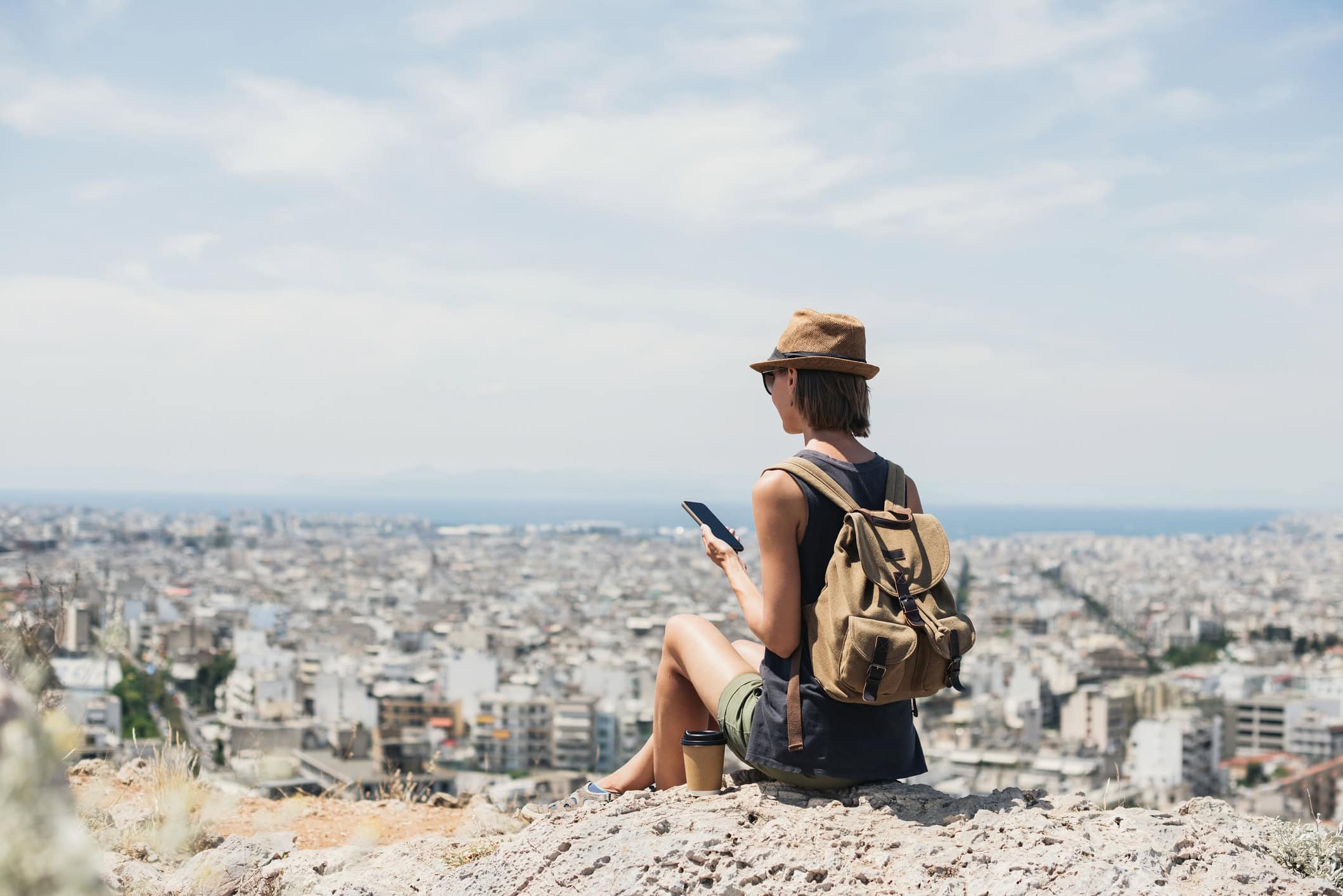 A traveler using her phone with an eSIM service in Italy (photo: Poike, iStock license).