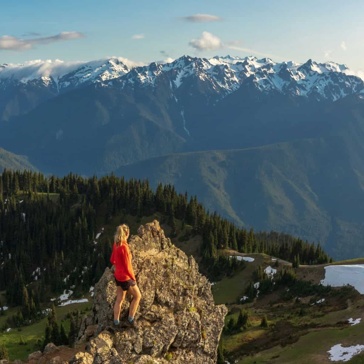A hiker on a mountain trip looks toward Hurricane Ridge in Olympic National Park, WA (photo: Susan Flynn, Unsplash).