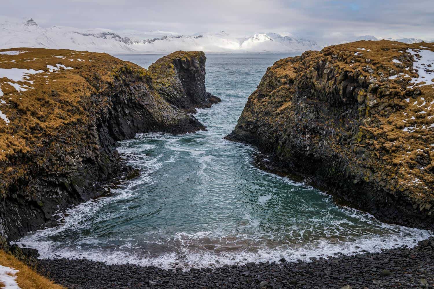 Moss-covered volcanic cliffs and a sea stack in a North Iceland bay (photo: Magic K, Pexels).