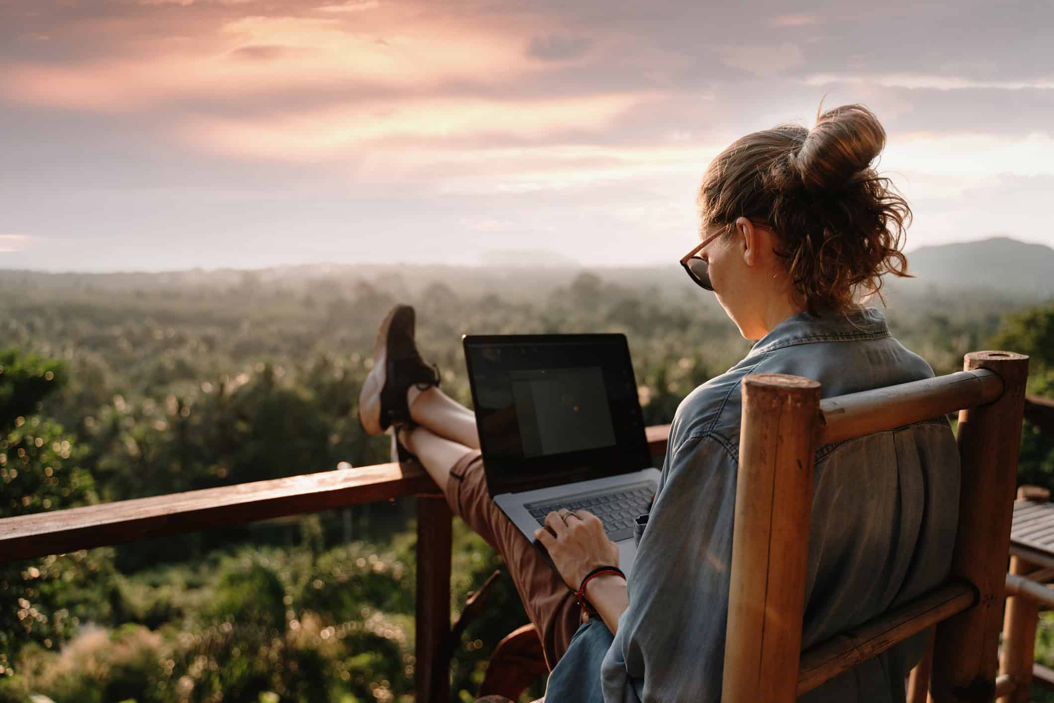 A woman practicing safe travel booking online in Thailand (photo: Olezzo, iStock).