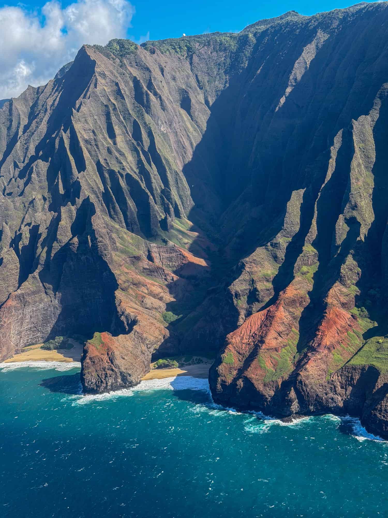 Sheer ridges plunge straight into the Pacific Ocean along Kauai's Na Pali Coast.