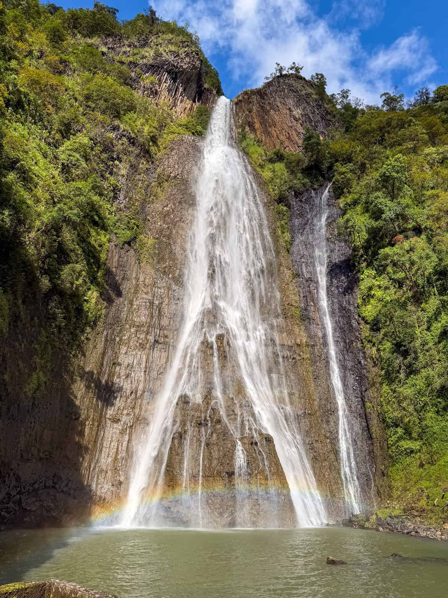 Rainbow at Manawaiopuna Falls as seen on a Jurassic Park helicopter tour.