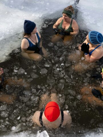 Women doing a cold plunge in Maine (photo: Gin Majka, Unsplash).