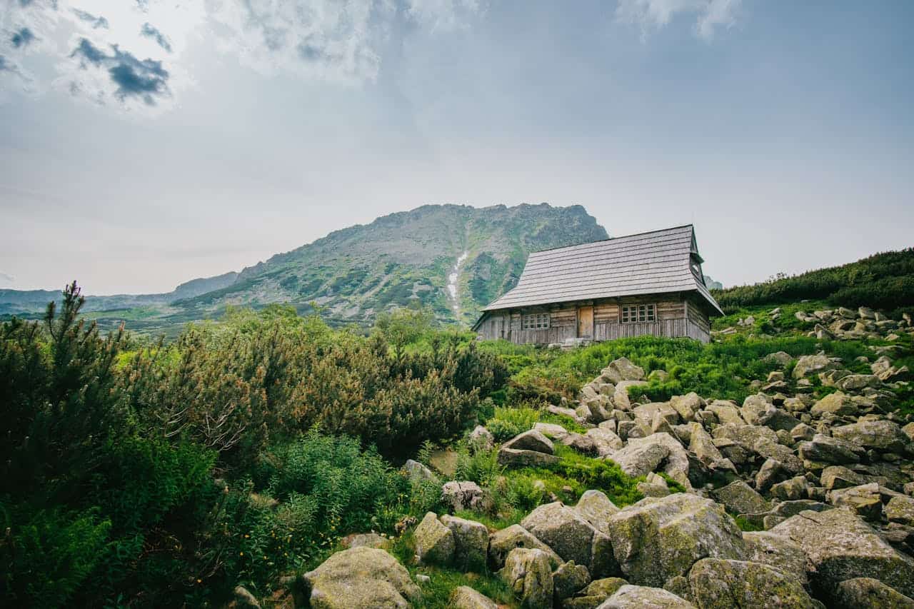 A lone wooden hut among rocks and dwarf pines in the high Tatras Mountains of Poland (photo: Pexels).
