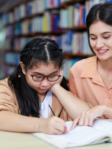 TEFL teacher helping a student with an English lesson in Thailand