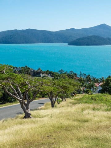 Golf buggy driving on Hamilton Island overlooking the Whitsundays in Queensland, Australia.