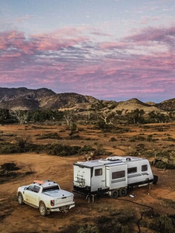 Luxury caravan and pickup truck camping in the Flinders Ranges of South Australia at sunset