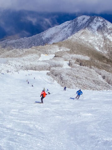 Skiers on Little Buller Spur at Mt Buller ski resort in Victoria, Australia after a snowstorm.