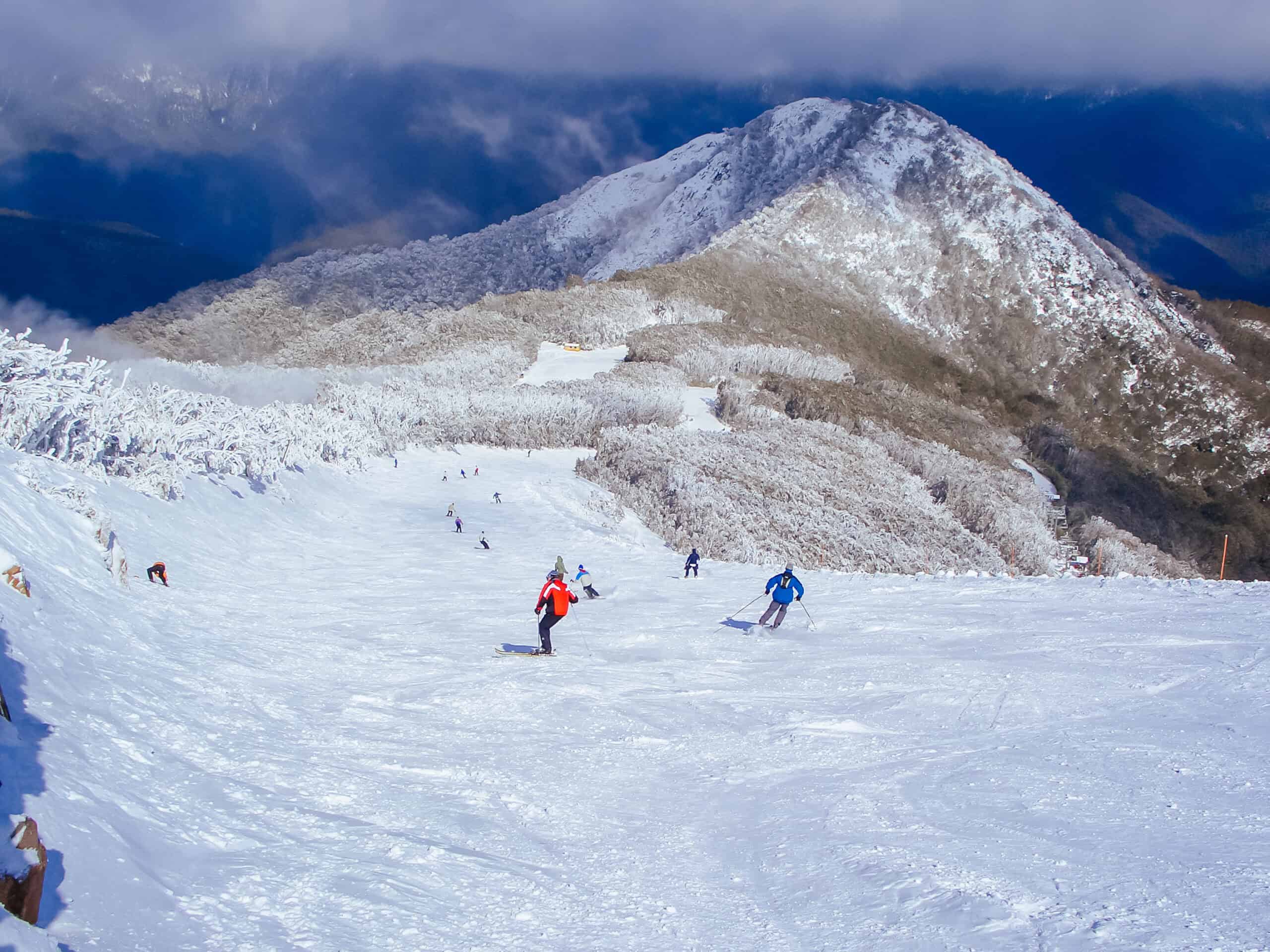 Skiers on Little Buller Spur at Mt Buller ski resort in Victoria, Australia after a snowstorm.