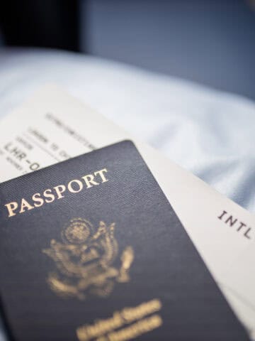 U.S. passport resting on top of an airline boarding pass before an international trip.