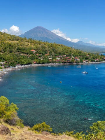 Aerial view of Amed's coastline with Mount Agung in the background, Bali, Indonesia.
