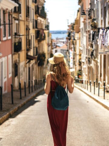 Traveler walking through a residential neighborhood in Lisbon, Portugal