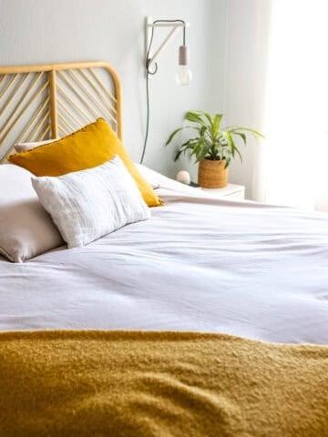 Freshly made bed in a bright, welcoming bedroom