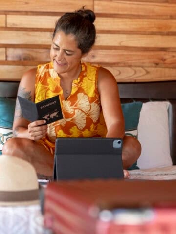 Traveler reviewing her passport while preparing for life abroad