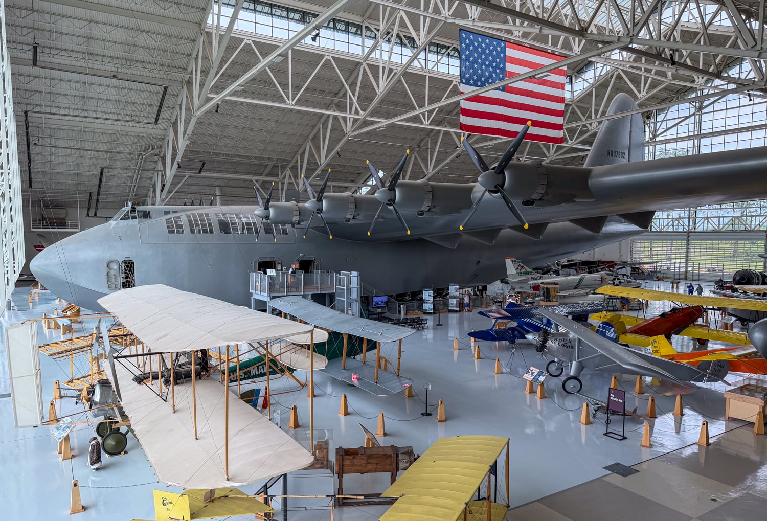 Spruce Goose flying boat displayed above smaller historic aircraft at the Evergreen Aviation & Space Museum in Oregon.